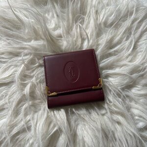 Vintage Cartier coin purse.  Burgundy leather and gold trim and snap closure.